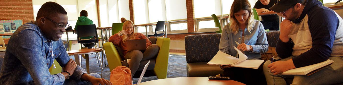 Students hanging out in a residence hall lounge area